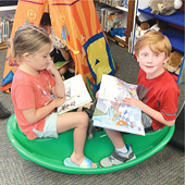 Photo of two children with books at Honey Grove Library and Learning Center in Honey Grove, Texas